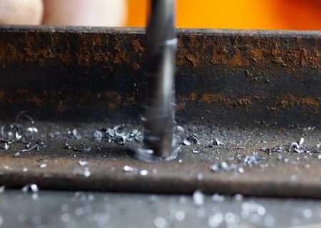 Drilling a hole in metal. Macro scaleの写真素材