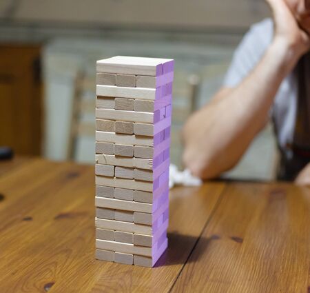 An exciting game for a large company. Across the table sits an engrossed thoughtful guy