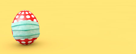 Easter red egg with white polka dots in a medical mask on a yellow background-protection against coronavirus. Banner format. The concept of health. Easter illustration. 3D renderの写真素材