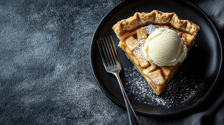 A tempting slice of apple pie topped with a scoop of ice cream on a black plate. The tempting dessert is perfect for gatherings or quiet nights.の素材