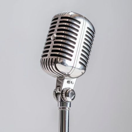 A stylish vintage silver microphone stands elegantly on a modern backdrop, symbolizing audio excellence in music and performance. Ideal for creative projects.の素材