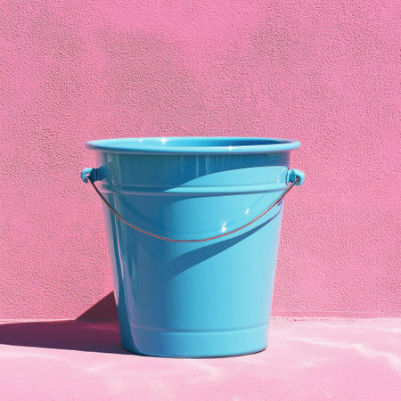A vibrant blue bucket stands against a striking pink background, creating a bold visual contrast perfect for creative projects and modern design.の素材