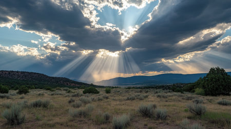 Dramatic cloudy sky with rays of sunlight breaking through the gapsの素材