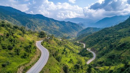 Long winding road cutting through a serene valley, surrounded by vibrant greenery and open skiesの素材