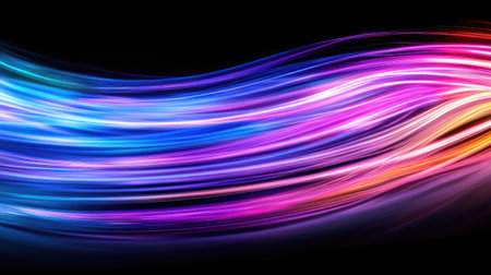 Colorful light waves flow gracefully across a dark background, creating an abstract visual of energy and motion. This vibrant image inspires creativity and beauty.の素材