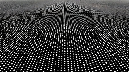 This abstract image features a black and white pattern of evenly spaced dots, creating a visually striking and captivating texture that draws interest.の素材