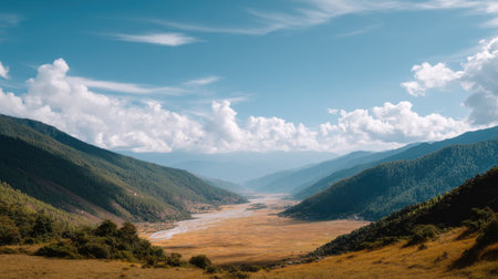 Breathtaking view of a serene valley surrounded by rolling hills and vibrant nature, showcasing the beauty of the outdoors in a tranquil setting.の素材