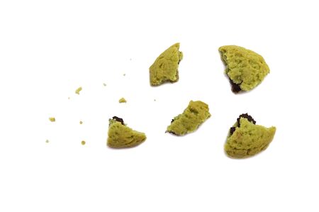 Crumbs of soft cookies green tea flavored filled with chocolate cream on white background.の写真素材