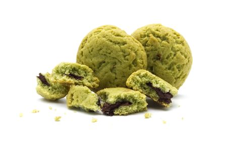 Crumbs of soft cookies green tea flavored filled with chocolate cream on white background.の写真素材