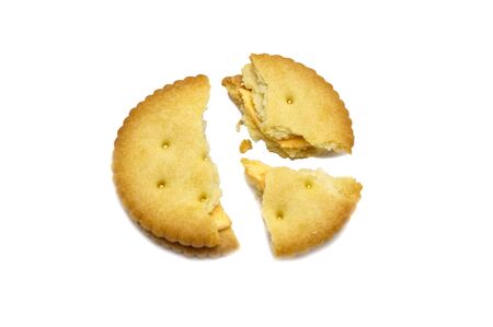 Biscuit broken with crumbs. Sandwich cracker Cheese flavoured ,Cream and butter. Crunchy delicious sweet meal and useful cookies. Isolated on white background. の写真素材