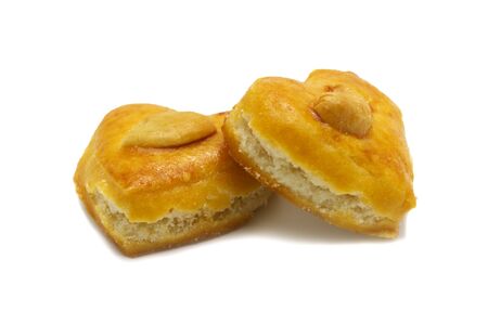 Cashew nut or Singapore cookies of heart shape isolated on white background for valentine's day or other celebration element concept design.の写真素材