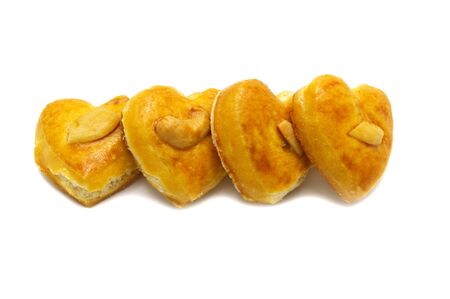 Cashew nut or Singapore cookies of heart shape isolated on white background for valentine's day or...