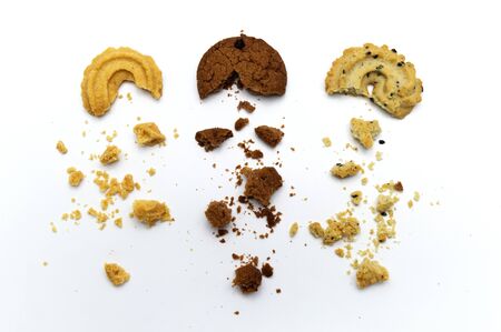 Collection of cookies or biscuit and crumbs with different flavor, chocolate chip butter, vanilla and black sesame. On white background.の写真素材