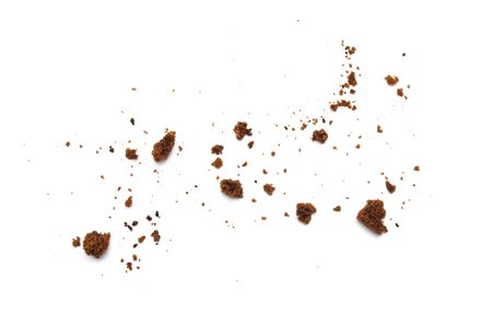 Scattered crumbs of chocolate chip cookies isolated on white background.の写真素材