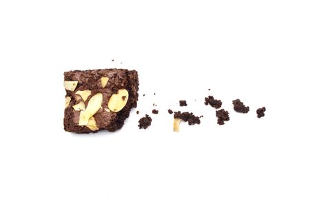 Chocolate brownie with sliced almond nuts toppings crumbs isolated on white background.の写真素材