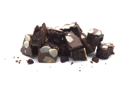 Pile of chocolate brownies with sliced almond nuts toppings broken and crumbs isolated on white background.の写真素材
