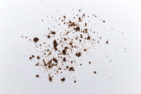 Scattered crumbs of chocolate chip cookies on white background.の写真素材