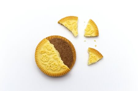 Sandwich cookie filled with coffee cream flavored. Some broken and crumbs of crunchy delicious sweet...