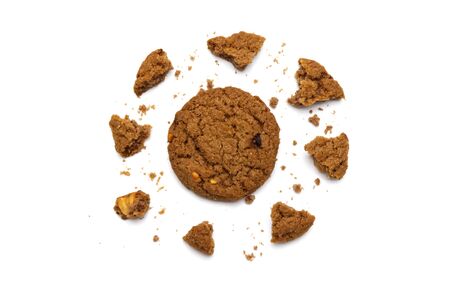 Biscuit with chocolate chip flavored. Some broken and crumbs of crunchy delicious sweet meal and useful cookie with on white background. の写真素材