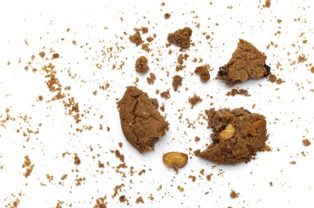 Cookies with chocolate chip flavored. Some broken and crumbs of crunchy delicious sweet meal and useful biscuits on white background.の写真素材