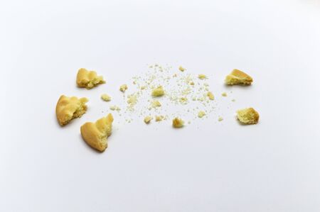 Sandwich cookies filled with coffee cream flavored. Some broken and crumbs of crunchy delicious sweet meal and useful cookie on white background.の写真素材