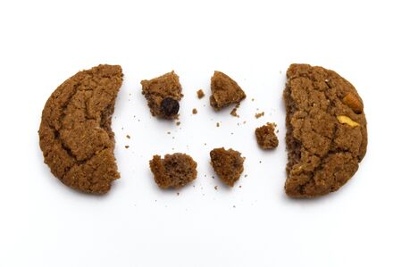 Biscuit with chocolate chip flavored. Some broken and crumbs of crunchy delicious sweet meal and useful cookie with on white background.の写真素材