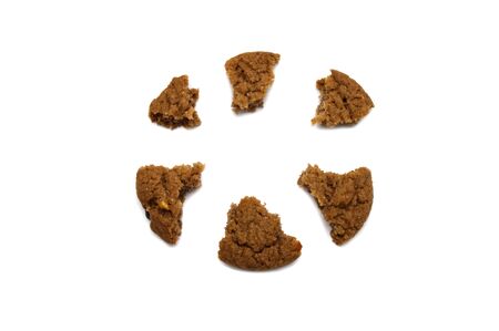 Biscuit with chocolate chip flavored. Some broken and crumbs of crunchy delicious sweet meal and useful cookie with isolated on white background.の写真素材