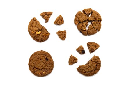 Biscuit with chocolate chip flavored. Some broken and crumbs of crunchy delicious sweet meal and useful cookie with isolated on white background.の写真素材