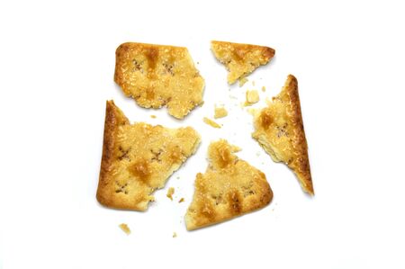 Broken square crackers biscuits isolated on white background. Crushed dry snack.の写真素材