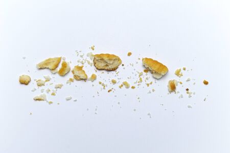 Crumbs of cookies on white background.