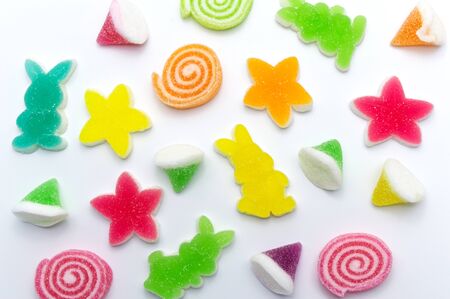 Assorted various bright candies colorful  gelatin jelly sweets, gummy sugary tasty. Soft gums viewed from above. On white background.の写真素材