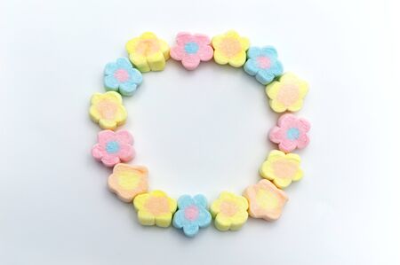 Pastel sweet flowers shape of marshmallows on white background. Copy space.の写真素材