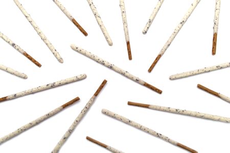 Chocolate biscuit stick coated with milk flavour confectionery and crushed cookies and cream taste isolated on white background.の写真素材