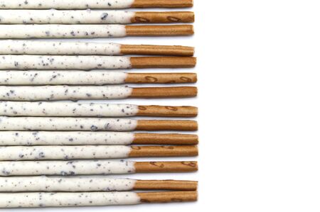 Chocolate biscuit stick coated with milk flavour confectionery and crushed cookies and cream taste isolated on white background.の写真素材