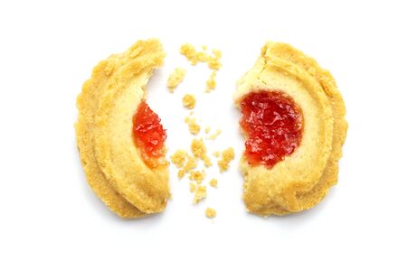Butter cookies strawberry jam topping flavored. Some cracks and crumbs. Crunchy delicious sweet meal...