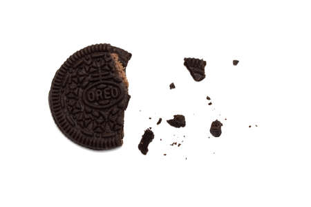 LAMPHUN, THAILAND - MARCH 19, 2019: Oreo Biscuits with crumbs  isolated on white background. It is a sandwich cookies filled with chocolate cream flavored. The best selling dessert in Thailand.のeditorial素材