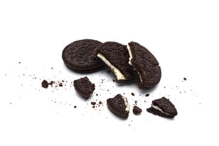 Oreo Biscuits with broken and  crumbs isloated on white background. It is a sandwich chocolate cookies with a sweet cream is the best selling dessert in Thailand.のeditorial素材