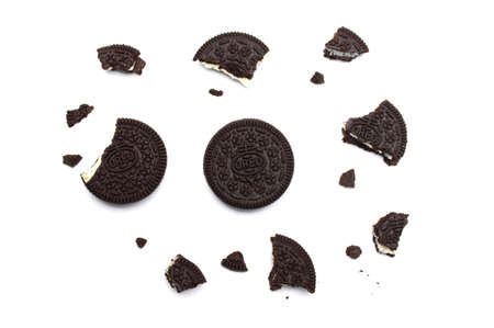 Oreo Biscuits with broken and crumbs isolated on white background. It is a sandwich chocolate cookies with a sweet cream is the best selling dessert in Thailand.のeditorial素材