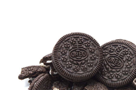 Oreo Biscuits isolated on white background. PIie of a sandwich cookies filled with sweet cream...