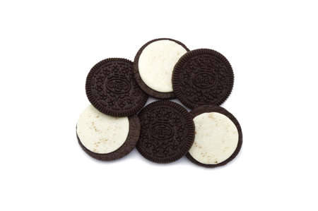 Oreo Biscuits in pieces of outside and inside isolated on white background. It is a sandwich chocolate cookies with a sweet cream.のeditorial素材