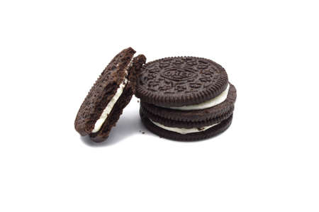 Oreo Biscuits with cracked and crumbs isolated on white background. It is a sandwich cookies filled with sweet cream flavored is the best selling in Thailand.のeditorial素材