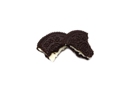 Oreo Biscuits cracked isolated on white background. It is a sandwich cookies filled with sweet cream flavored is the best selling dessert in Thailand.のeditorial素材