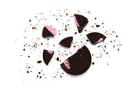 LAMPHUN, THAILAND - JULY 31, 2019: Oreo Biscuits with crumbs on white background. It is a chocolate sandwich cookies with strawberry flavored cream is the best selling dessert in Thailand.のeditorial素材