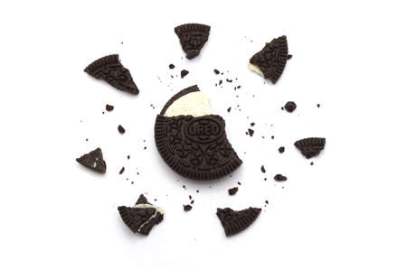LAMPHUN, THAILAND - JUNE 17, 2019: Oreo Biscuits with crumbs on white background. It is a sandwich cookies filled with chocolate cream flavored. The best selling dessert in Thailand.のeditorial素材