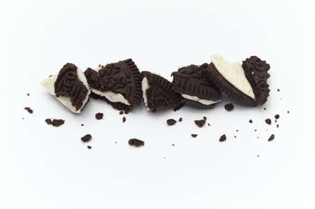 LAMPHUN, THAILAND - JUNE 17, 2019: Oreo Biscuits with crumbs on white background. It is a sandwich cookies filled with chocolate cream flavored. The best selling dessert in Thailand.のeditorial素材