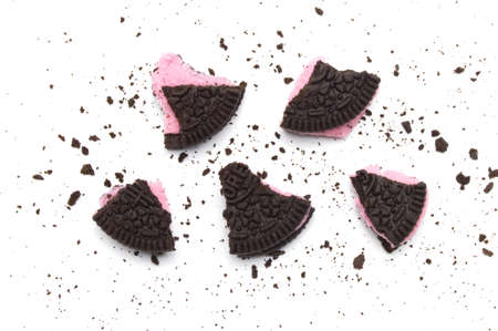 LAMPHUN, THAILAND - JUNE 19, 2019: Oreo Biscuits with crumbs on white background. It is a chocolate sandwich cookies with strawberry flavored cream is the best selling dessert in Thailand.のeditorial素材