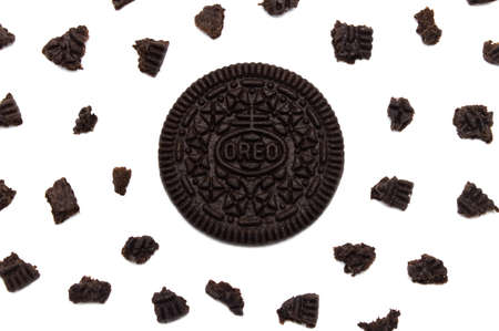 LAMPHUN, THAILAND - JUNE 24, 2019: Oreo Biscuits with crumbs isolated on white background. It is a sandwich chocolate cookies with a sweet cream is the best selling dessert in Thailand.のeditorial素材