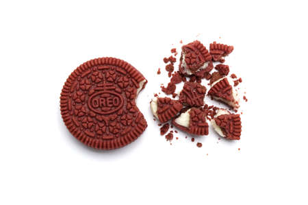 Oreo Biscuits and crumbs on white background. It is a Red velvet sandwich cookies with cheesecake flavored cream. Limited edition of Oreo in Thailand.のeditorial素材