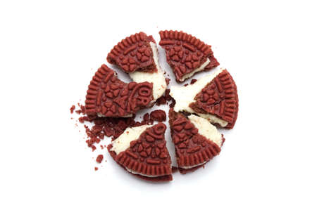 Oreo Biscuits and crumbs on white background. It is a Red velvet sandwich cookies with cheesecake flavored cream. Limited edition of Oreo in Thailand.のeditorial素材