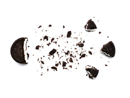 Sandwich chocolate cookies with a sweet cream with crumbs isolated on white background.の写真素材
